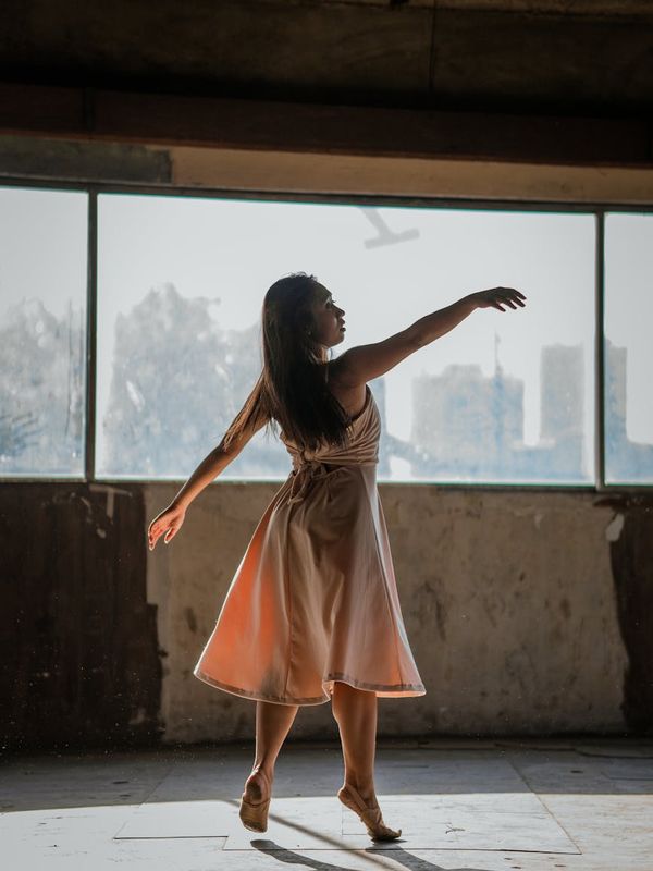 Silhouette of a person standing gracefully with lines indicating energy flow.